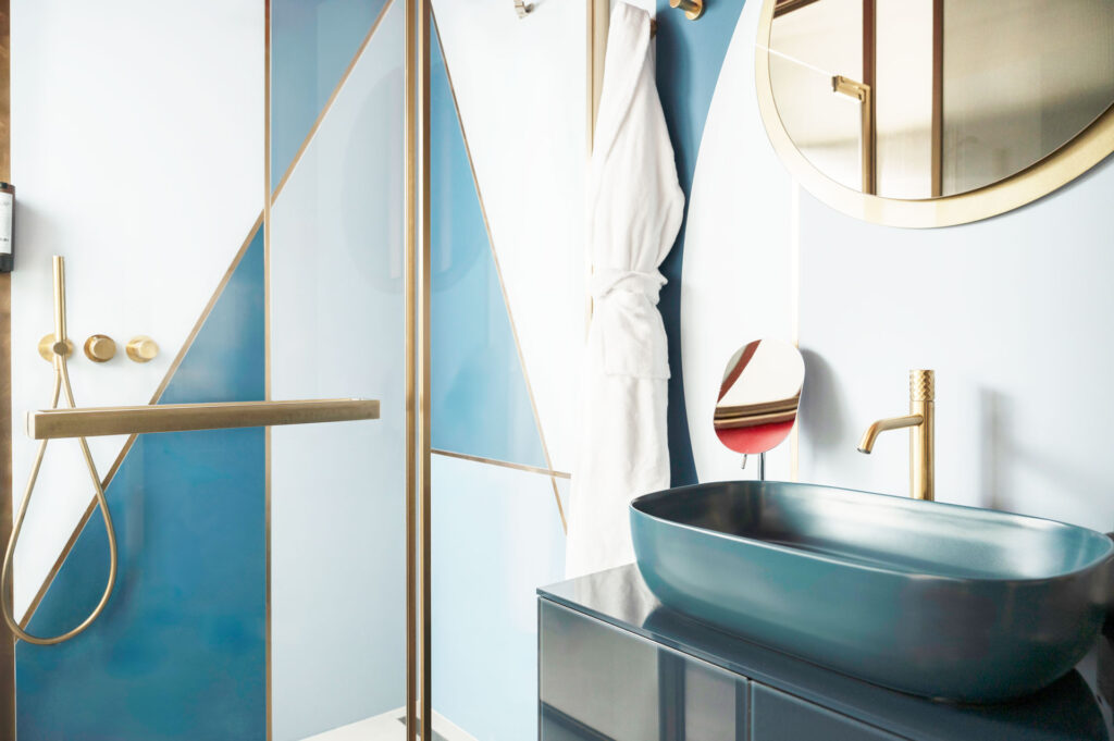 MODE Hotel SUITE ONIRICA parete divisoria GLASS pareti vetrate a vetro singolo in vetro cannettato fumè, smoked grey con profilo in alluminio Gold e porta scorrevole